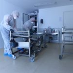 Nettoyeurs désinfectent une table d'autopsie